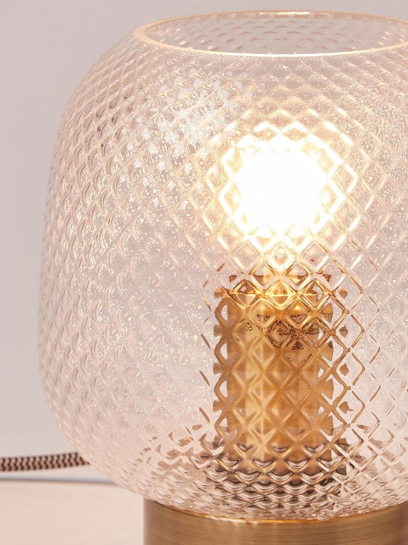 Oliver Bonas table lantern with textured glass shade and brass base, imported from the UK
