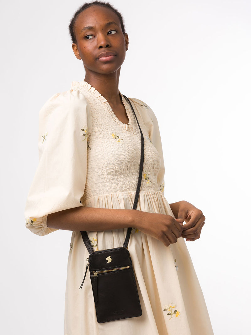 Conkca Black Bambino leather cross-body phone bag, imported from the UK