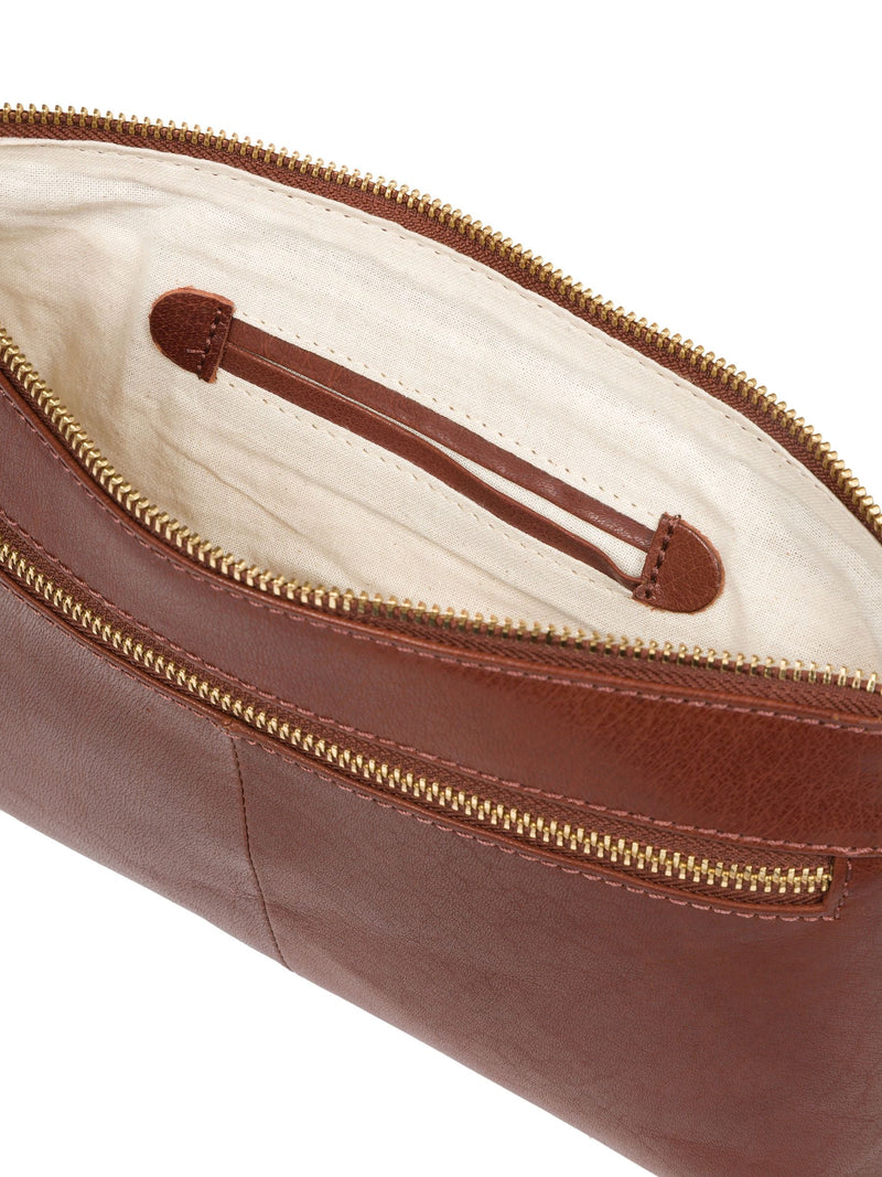 Conkca London leather clutch bag in conker brown, imported from the UK