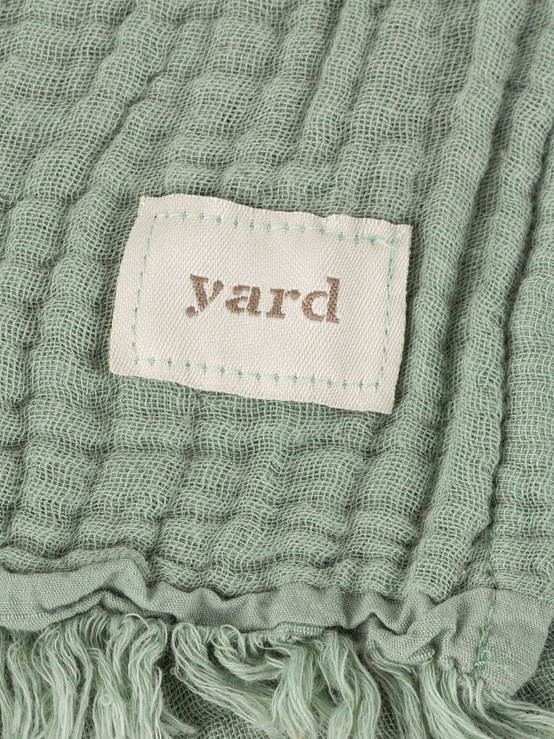 Lark muslin crinkle cotton throw in eucalyptus green (British brand)