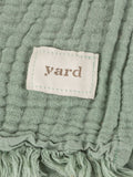 Lark muslin crinkle cotton throw in eucalyptus green (British brand)