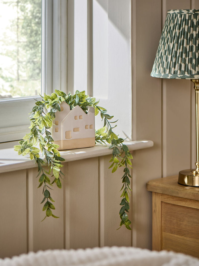 Artificial trailing plant in ceramic house shaped pot - British product