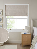 Natural textured blackout Roman blind with tassel edge, imported from the UK
