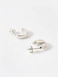 Oliver Bonas sterling silver huggie earrings with faceted surface, imported from the UK