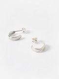 Oliver Bonas sterling silver huggie earrings with faceted surface, imported from the UK