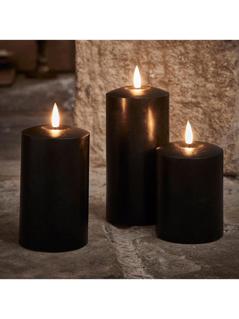 Lights4fun black TruGlow LED pillar candle trio with 15cm, 12.5cm, and 10cm heights, UK version