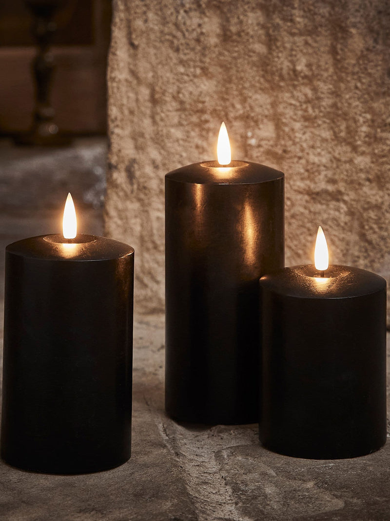 Lights4fun black TruGlow LED pillar candle trio with 15cm, 12.5cm, and 10cm heights, UK version