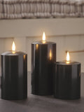 Lights4fun black TruGlow LED pillar candle trio with 15cm, 12.5cm, and 10cm heights, UK version