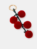 Accessorize fluffy tomato bag charm with pom-pom cherry tomatoes, imported from the UK