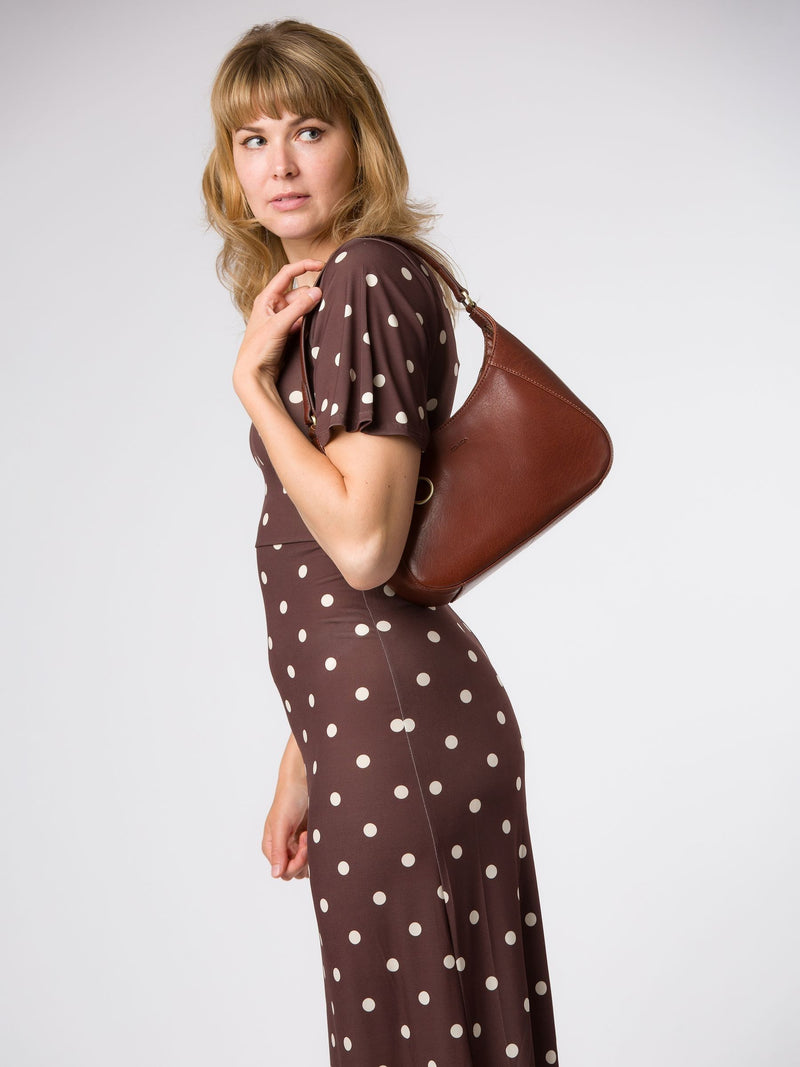 Conkca brown Vivienne leather grab bag with brass fittings, imported from the UK