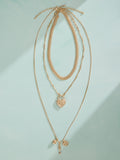 Tabitha Simmons gold tone layered charm necklace, imported from the UK