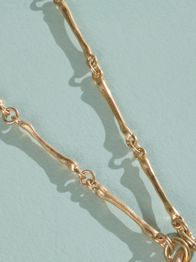 Tabitha Simmons gold tone layered charm necklace, imported from the UK