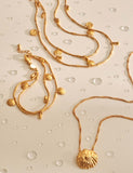 Katie Loxton gold plated bracelet with shell charms, imported from the UK