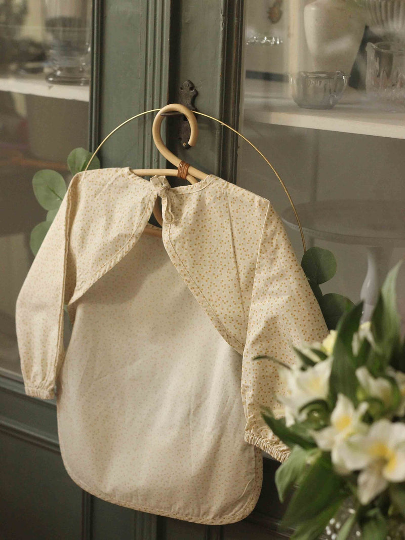Avery Row sleeved bib in Daisy Meadow pattern (British brand)
