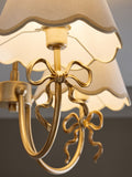 Brass bow chandelier with delicate scalloped shades - British product