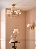 Brass bow chandelier with delicate scalloped shades - British product