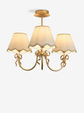 Brass bow chandelier with delicate scalloped shades - British product