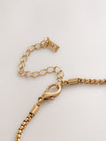 Gold tone flower necklace with long chain, UK version