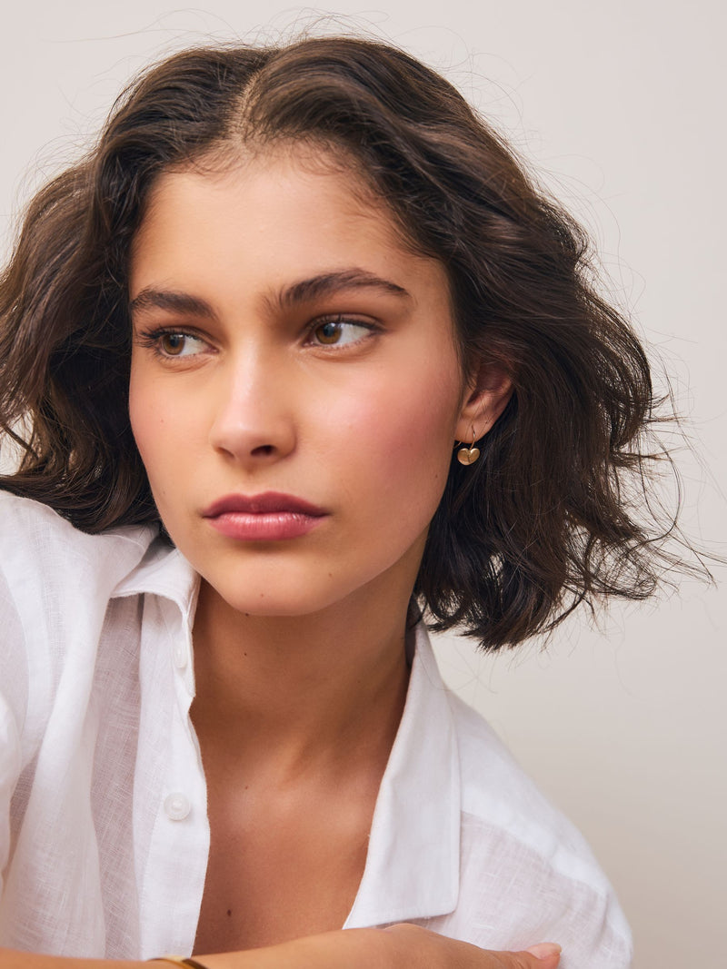 Brushed gold tone heart pierced earrings - British product
