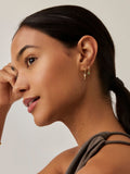 Missoma gold tone tennis charm mini hoop earrings, imported from the UK