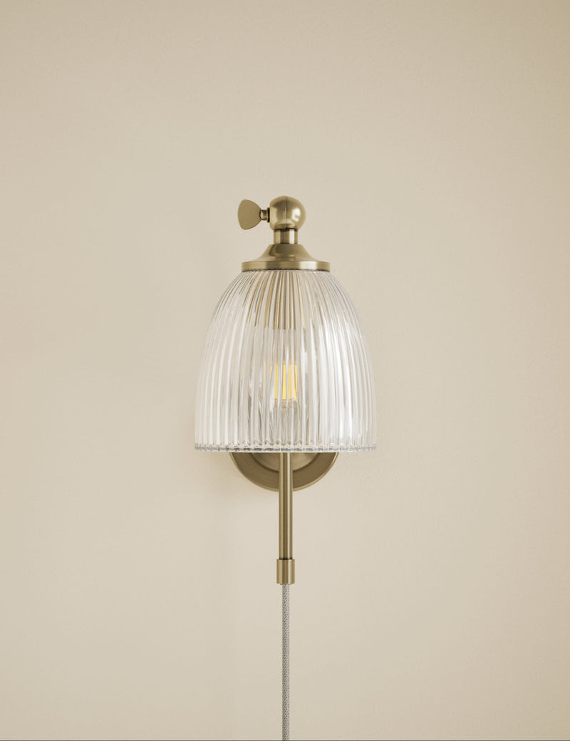 Ribbed plug in wall light with antique brass finish, imported from the UK