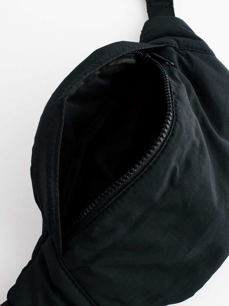 Black cross-body bag with nylon shell and polyester lining, UK version