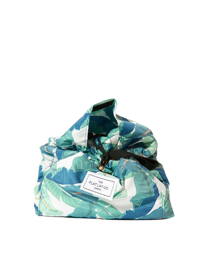 The Flat Lay Co. makeup bag Tropical Leaves design 52cm diameter, imported from the UK