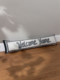 Furn black velvet draught excluder with mosaic welcome design (British brand)