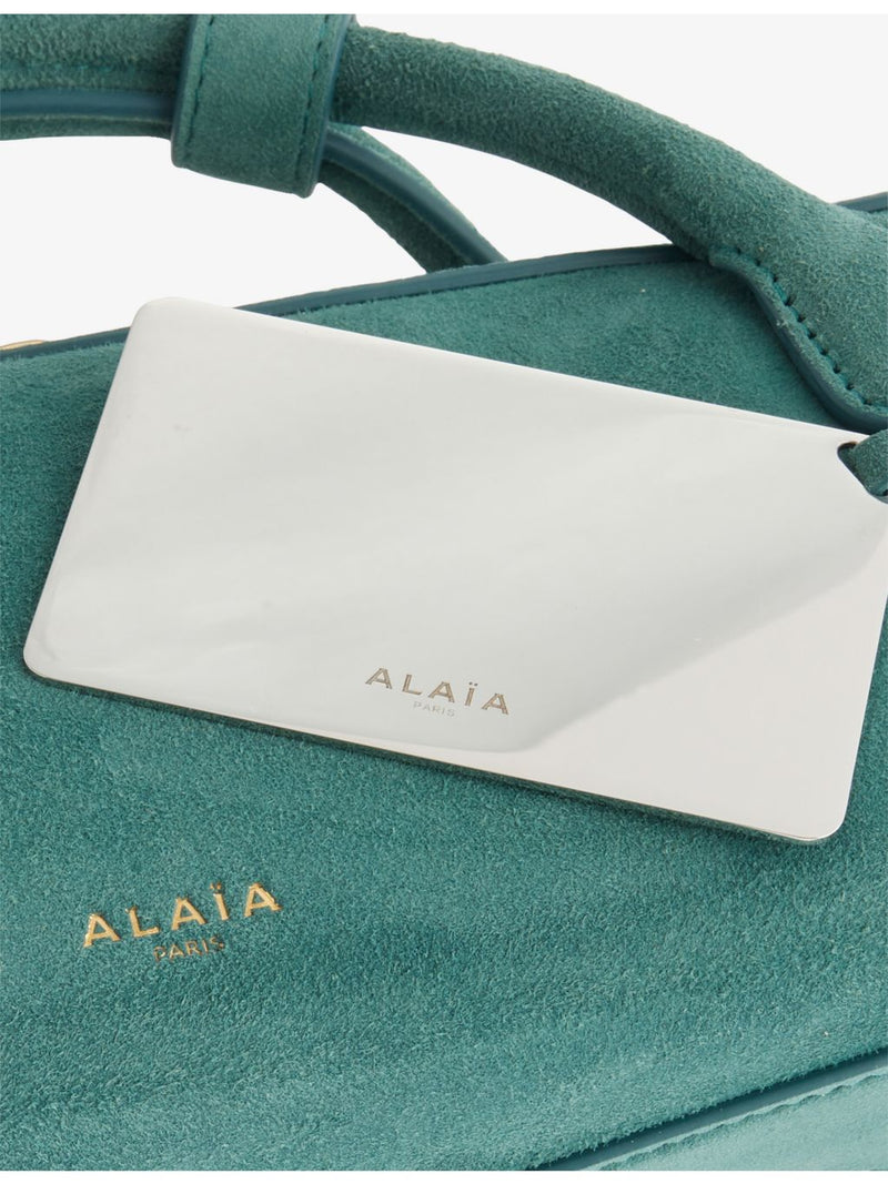 Alaïa suede clutch bag with gold-toned hardware, imported from the UK