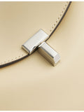 Totême Mini T-Lock leather clutch bag, imported from the UK