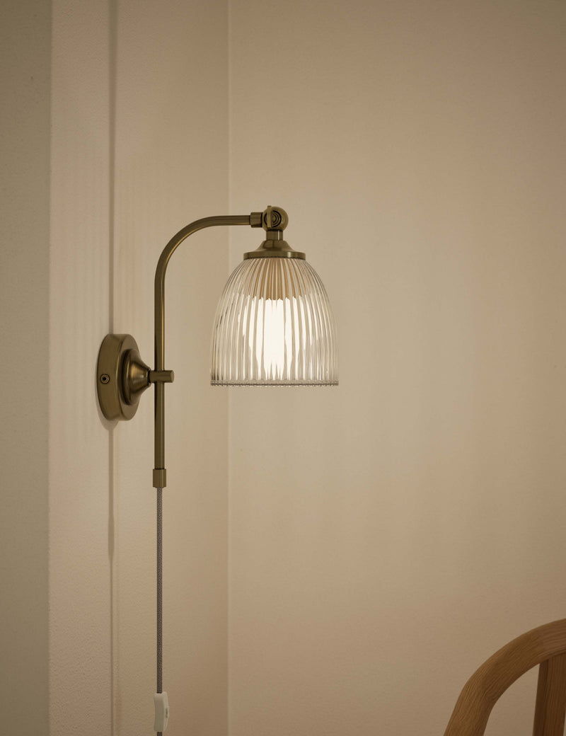 Ribbed plug in wall light with antique brass finish, imported from the UK