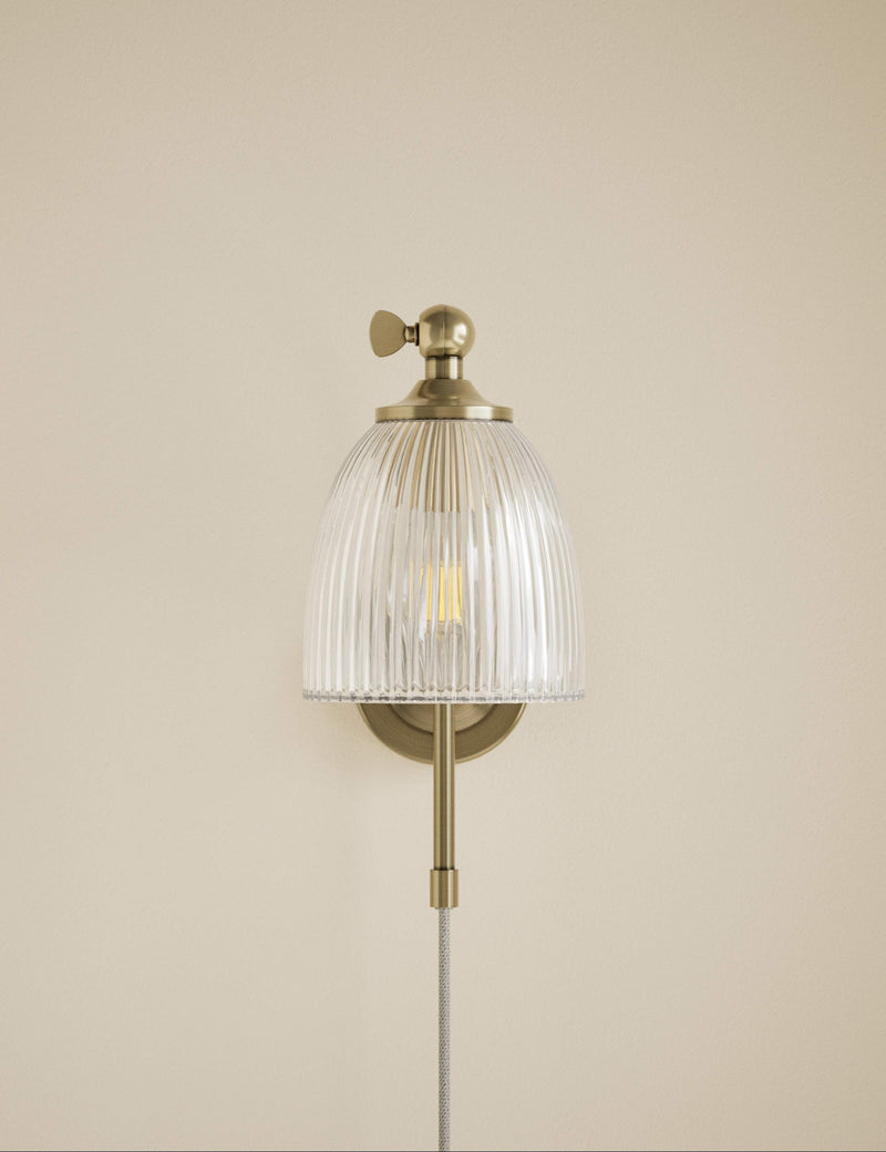 Ribbed plug in wall light with antique brass finish, imported from the UK
