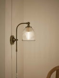 Ribbed plug in wall light with antique brass finish, imported from the UK