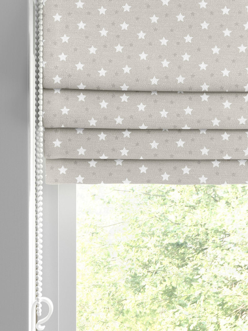 Roman blind with ditsy stars pattern in natural colour, imported from the UK