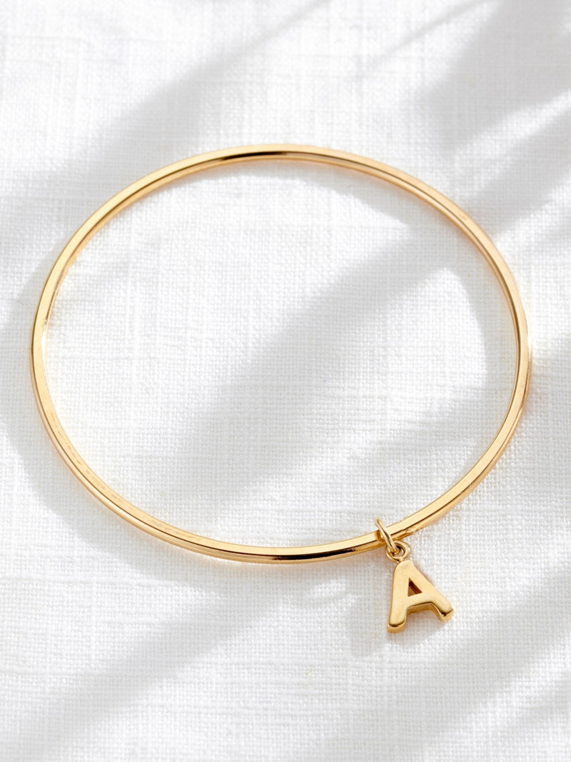 Posh Totty Designs gold tone chunky initial charm bangle, imported from the UK