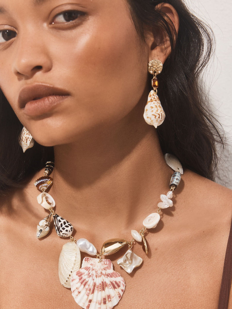 Gold tone shell drop earrings with gemstone accents (British brand)