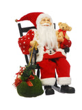 Santa figurine sitting in wooden rocking chair with snowman jumper (British brand)