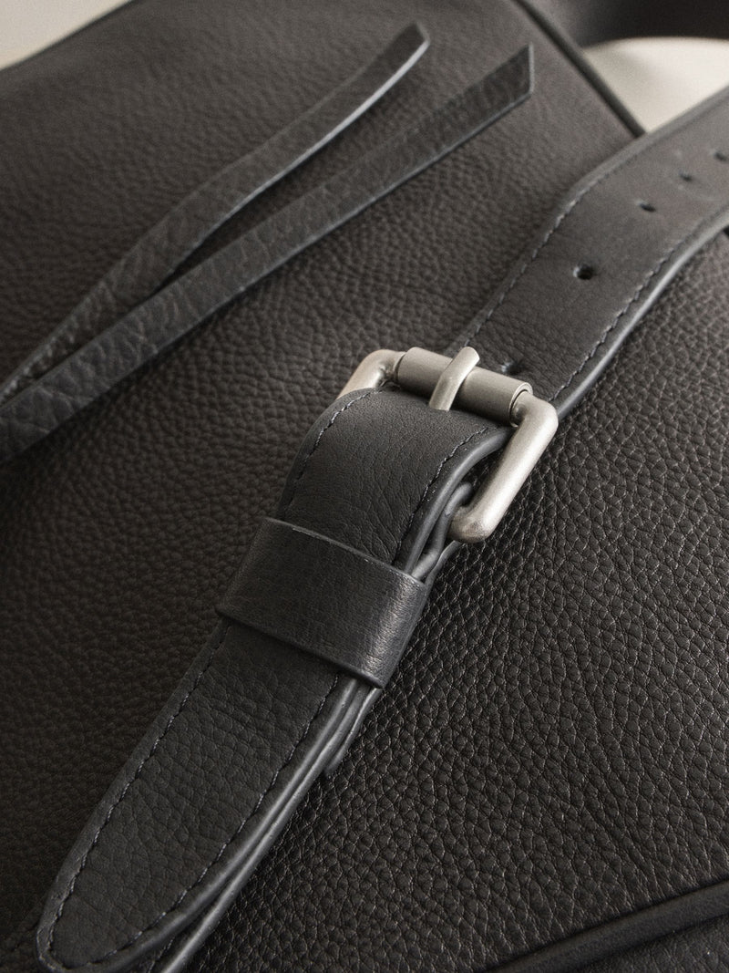 Black leather messenger bag with cross-body strap, UK version