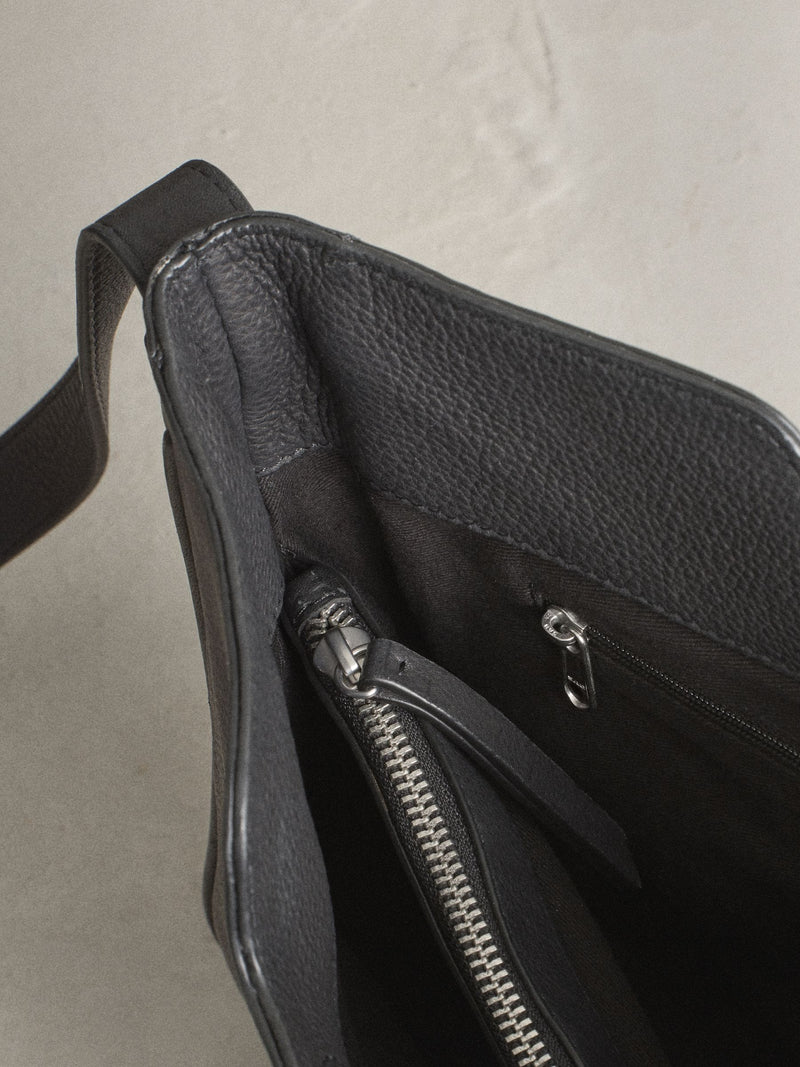 Black leather messenger bag with cross-body strap, UK version