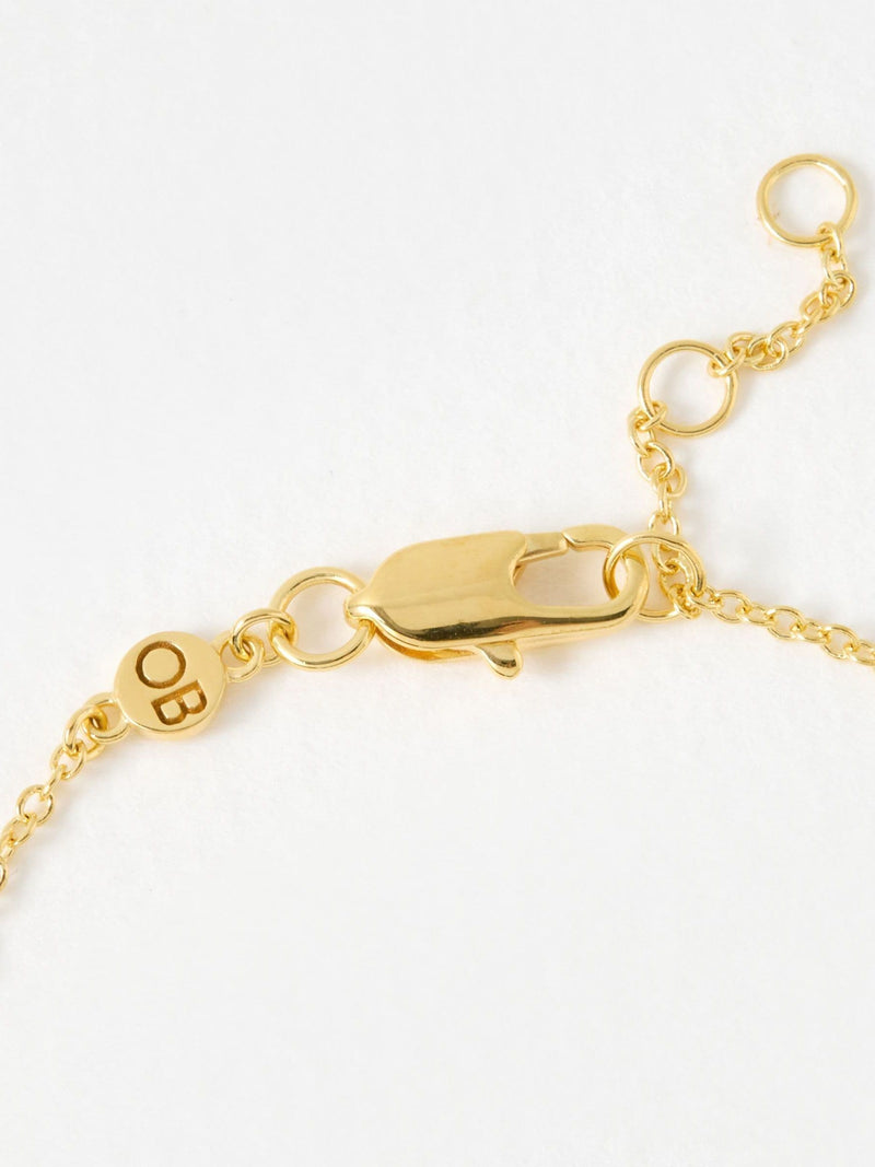Oliver Bonas gold tone paw print charm bracelet, imported from the UK