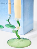 Oliver Bonas green glass candlestick holders with flower motifs, imported from the UK