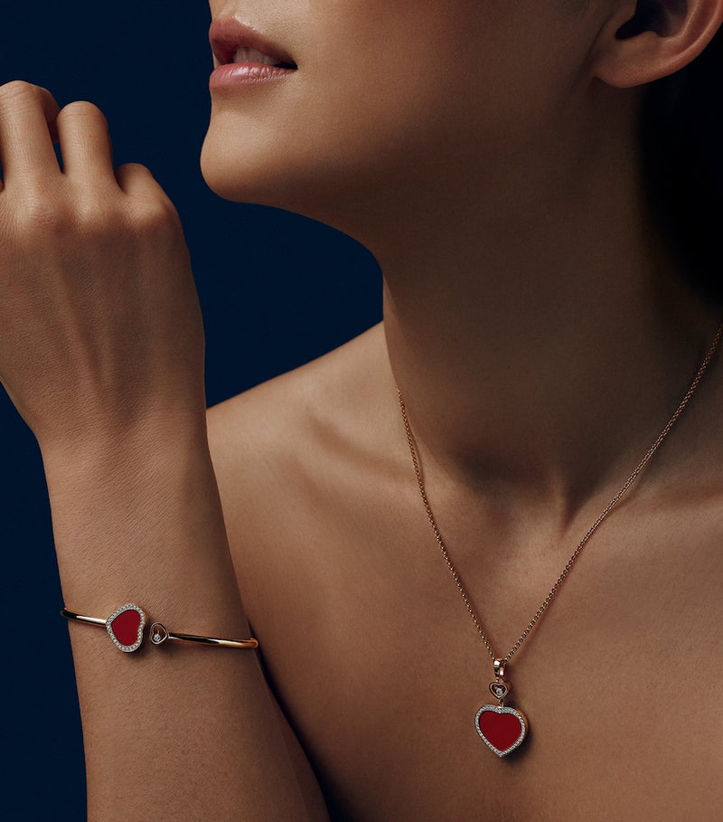 Chopard Happy Hearts rose gold bangle with moving diamond and red stone (British brand)