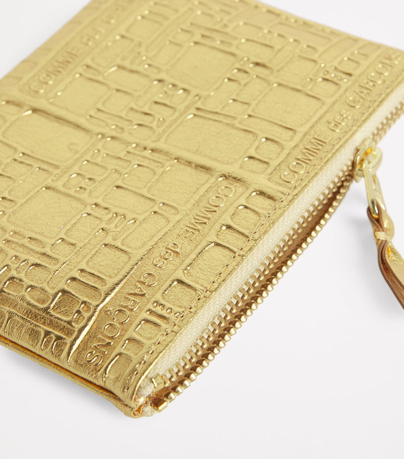 Comme des Garçons gold leather embossed zipped pouch, imported from the UK