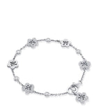 Boodles 18kt white gold diamond blossom charm bracelet, imported from the UK