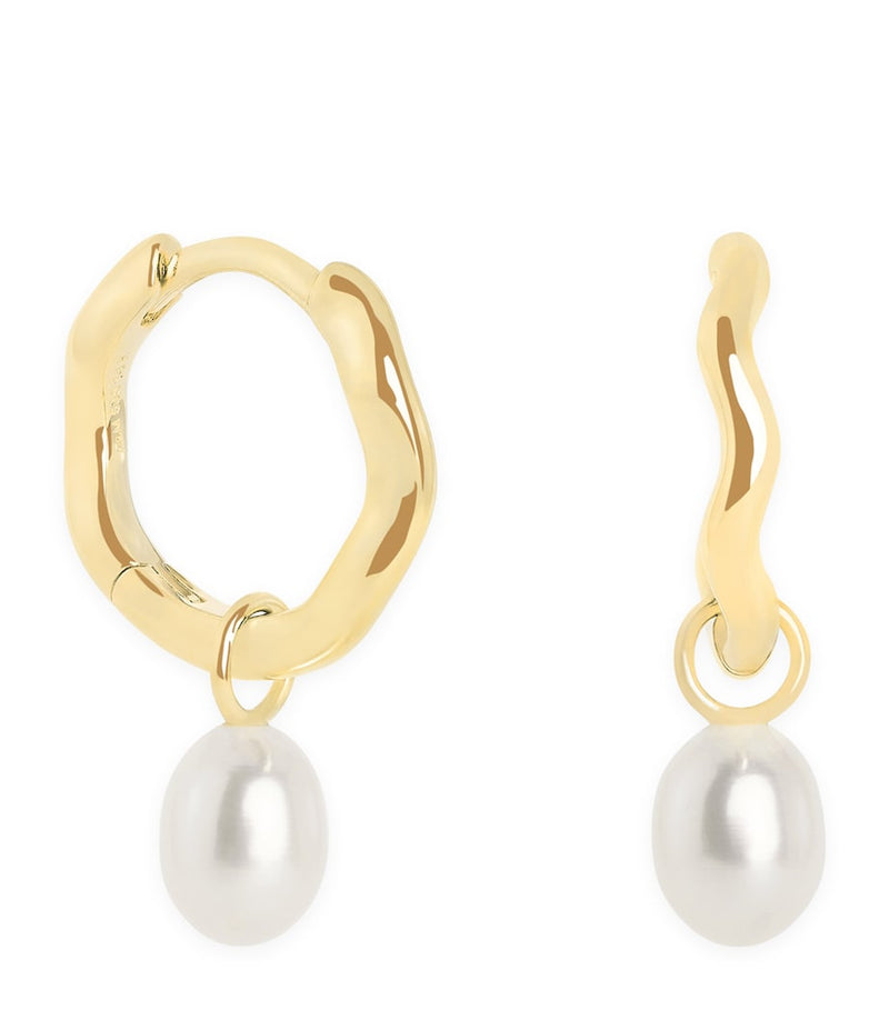 Astrid & Miyu yellow gold pearl wave huggie earrings, imported from the UK