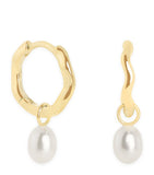 Astrid & Miyu yellow gold pearl wave huggie earrings, imported from the UK