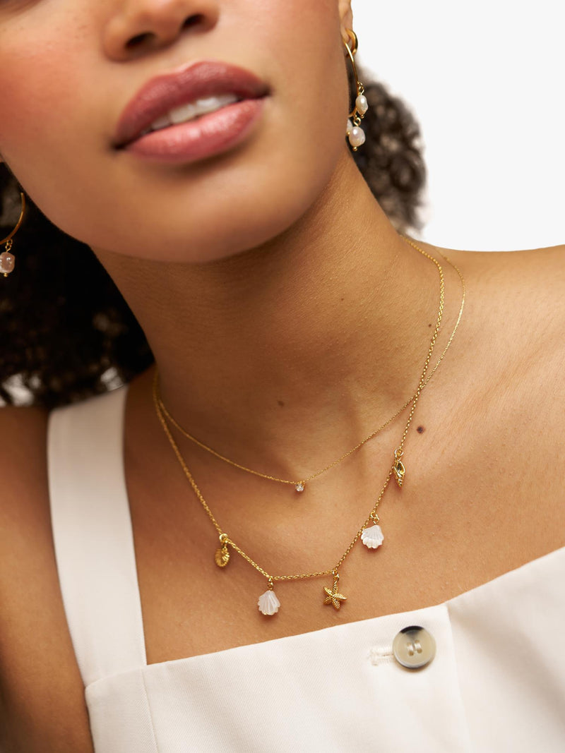 Orelia gold charm necklace with shell and starfish charms - British product