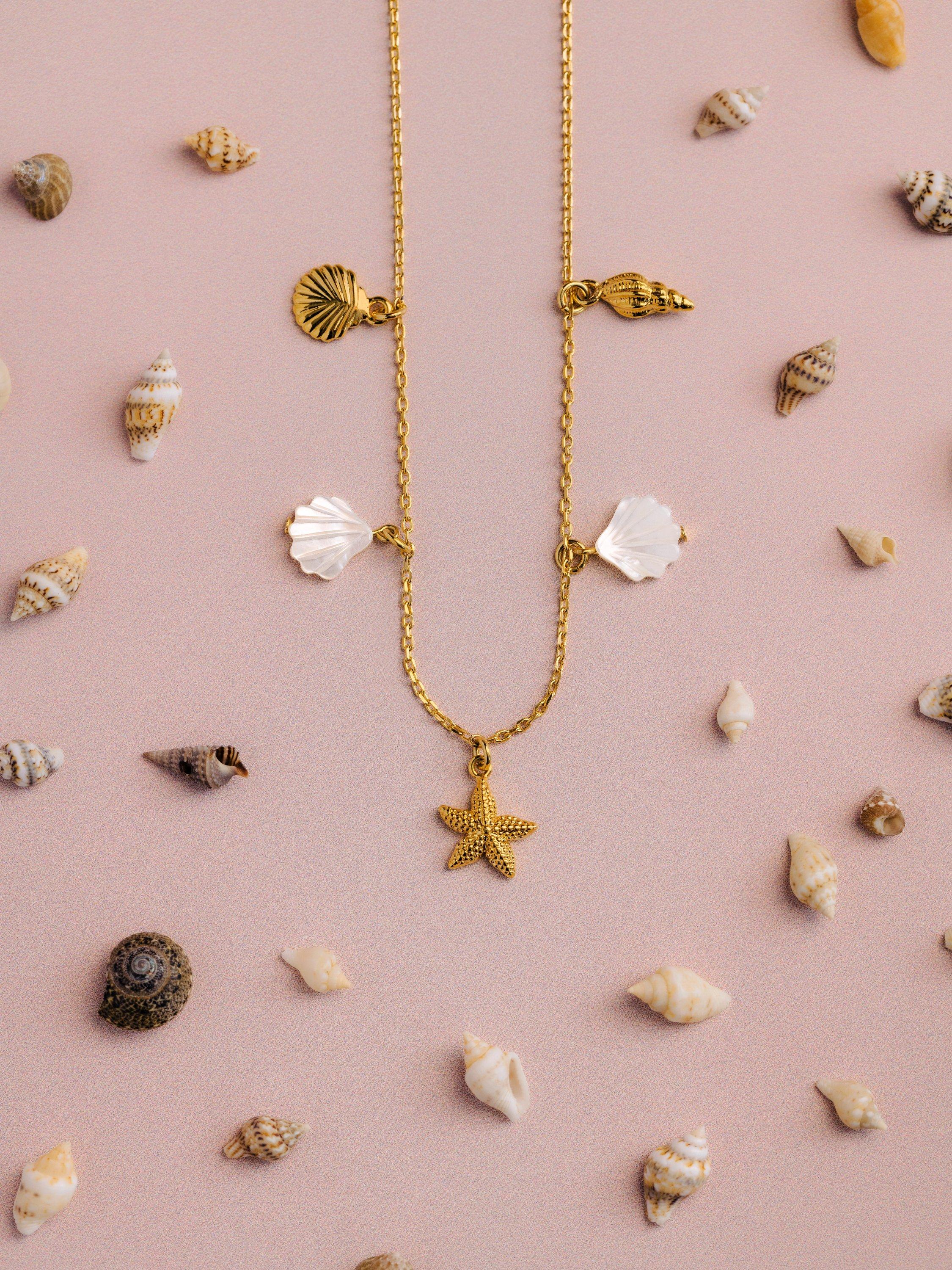 Orelia gold charm necklace with shell and starfish charms - British product