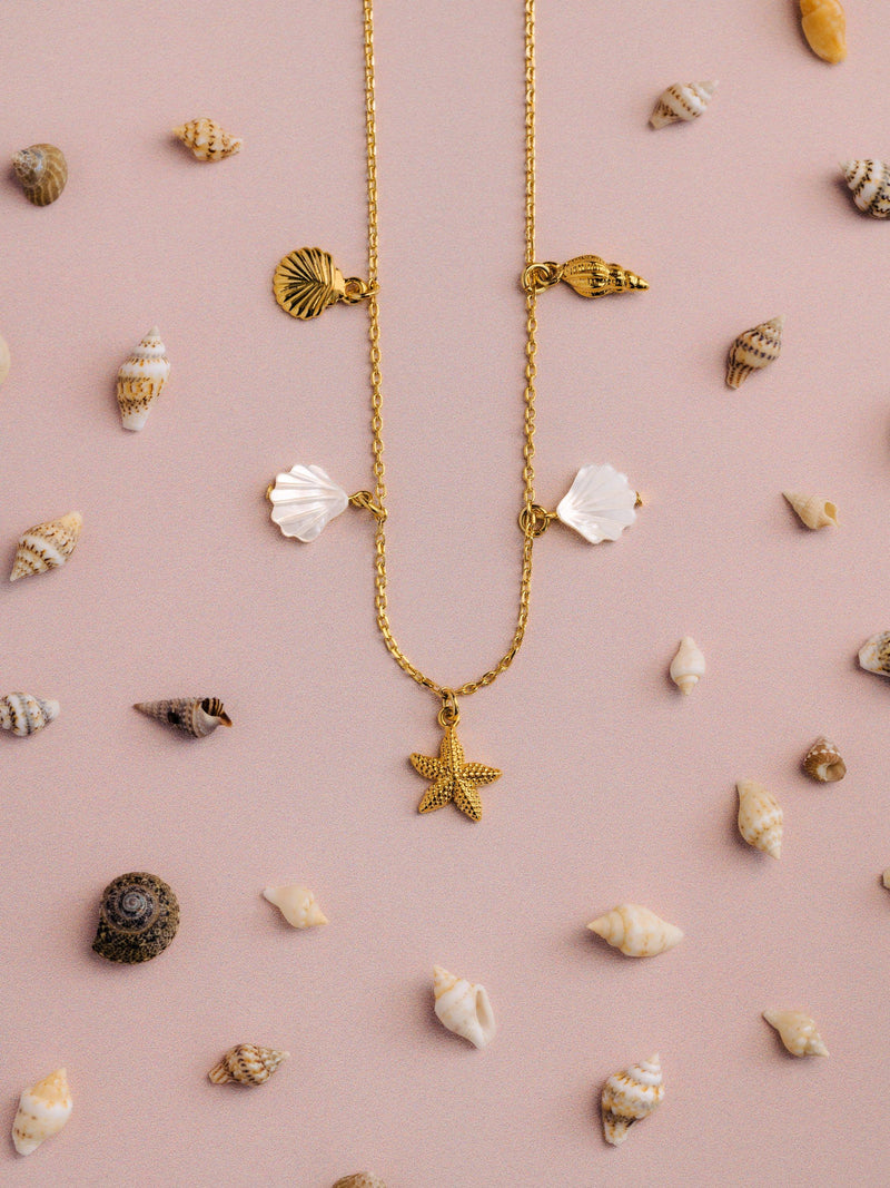 Orelia gold charm necklace with shell and starfish charms - British product