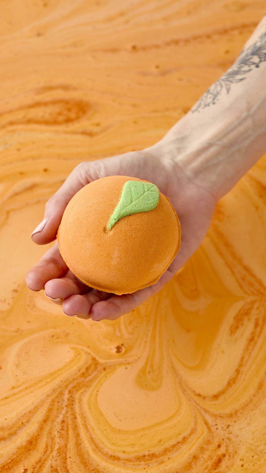 Lush whole fruit bath bomb in uplifting orange scent, UK version